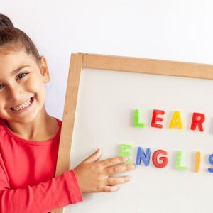 Language education concept. Learn English. Do you speak English. Cute little child girl with letters on the blackboard. English language school. English for children.